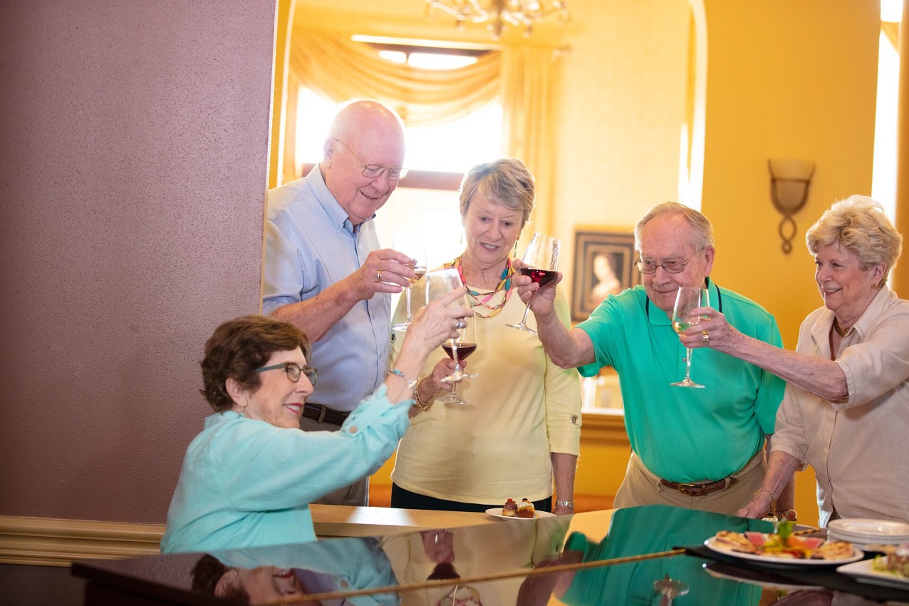 Senior adults socializing with wine