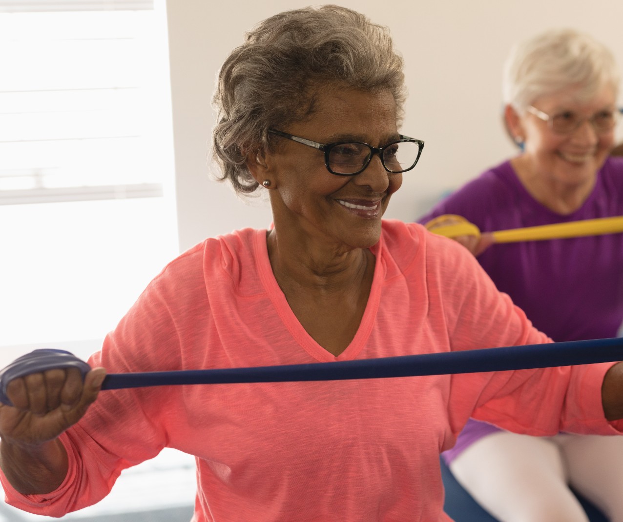 Senior women exercising with bands for healthy senior living